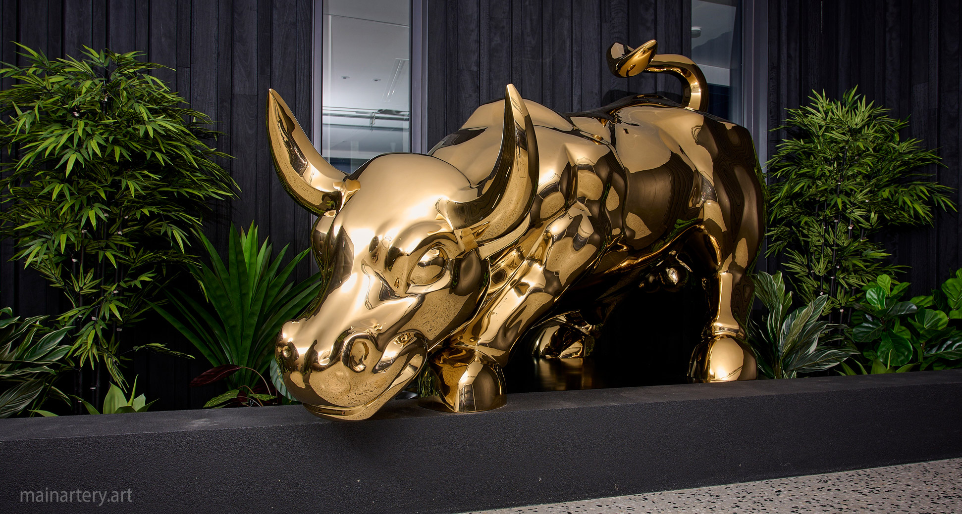 monumental gold titanium bull landmark sculpture image